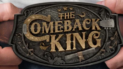 a belt buckle with two hands holding it