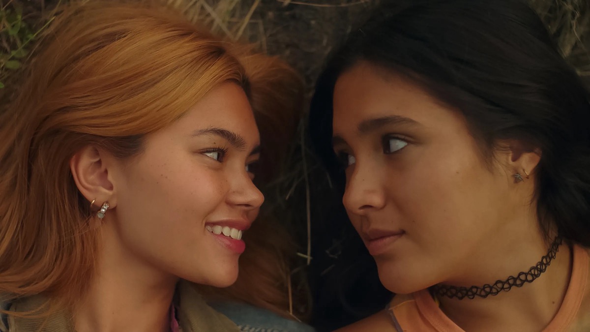 Two teenage girls look longingly at each other in "Girls Like Girls"