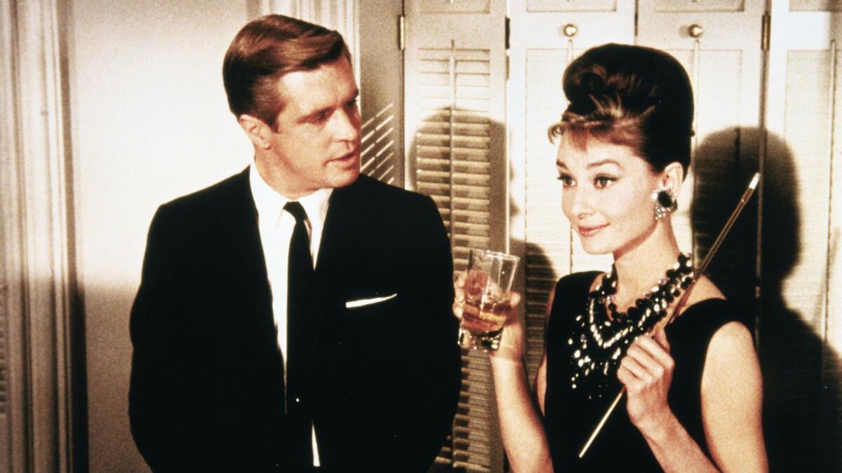 A glamorous couple talks in "Breakfast at Tiffany's"