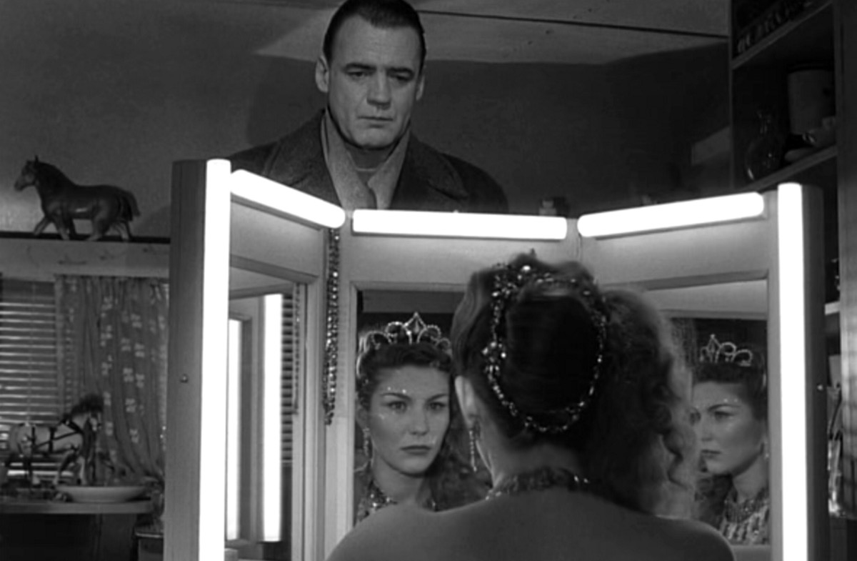 An angel watches a showgirl in her dressing room in Wings of Desire