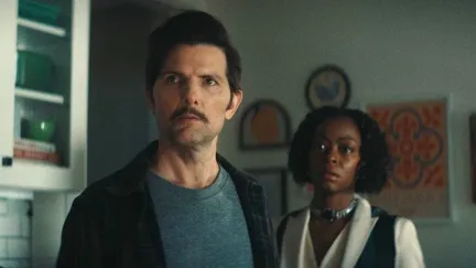 two people standing in a kitchen