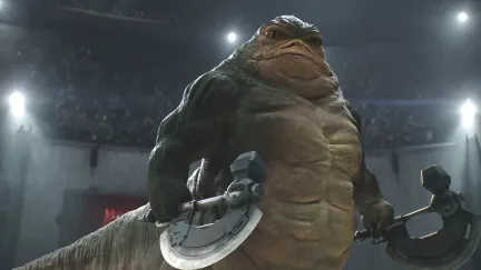a hutt standing with an ax