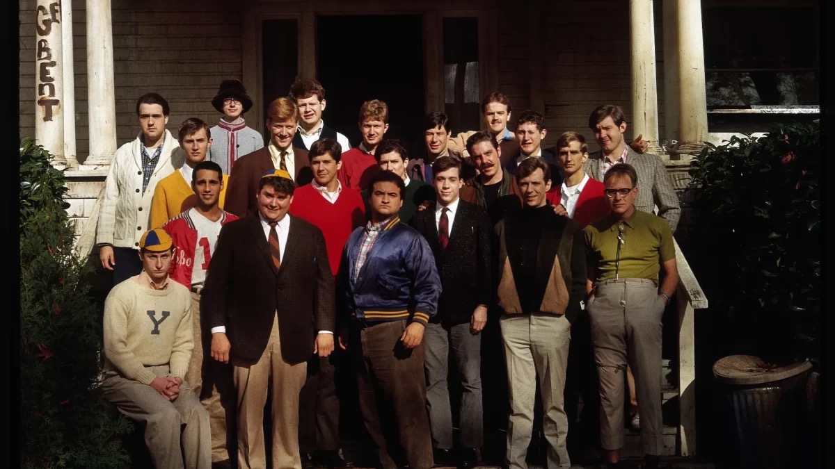 The cast of Animal House on the steps of a frat house