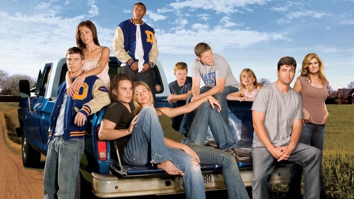 The cast of Friday Night Lights sitting by a truck