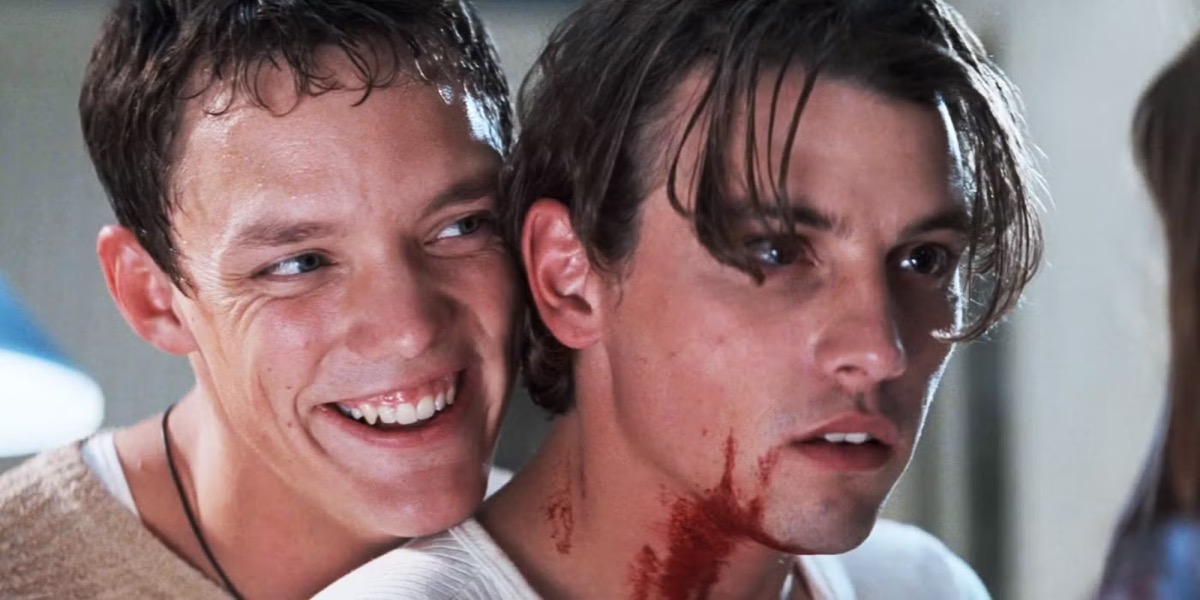 Two bloodcovered young men hold each other in Scream