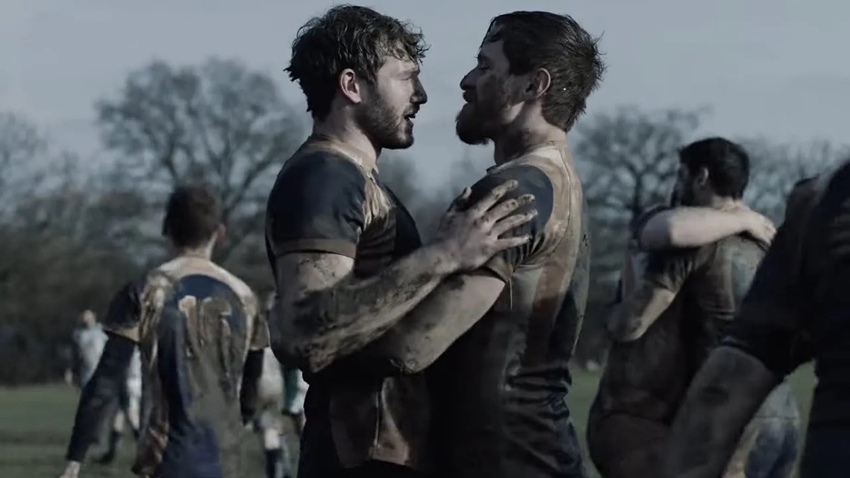Two rugby players embrace in From the Side