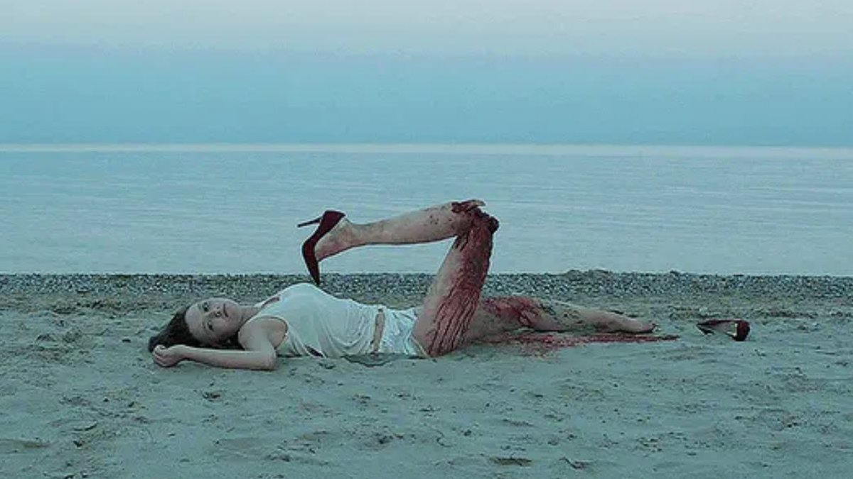 A girl lies dead on a beach in It Follows