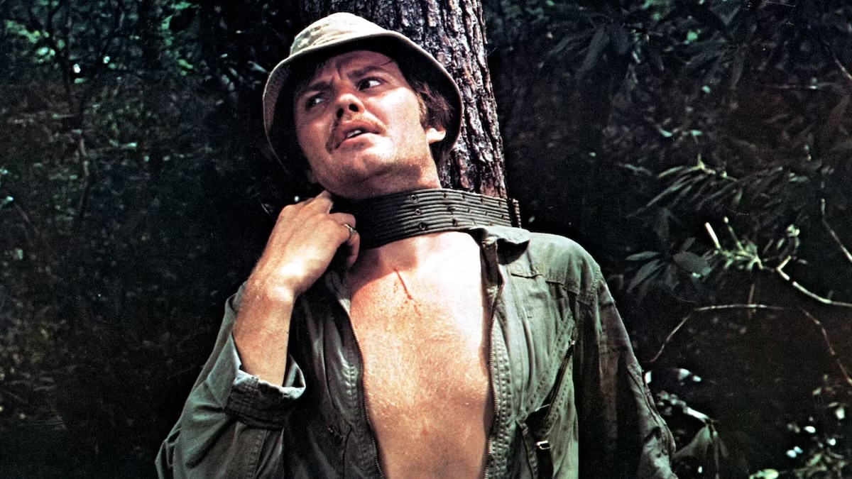 A man tied to a tree struggles against the ropes in Deliverance