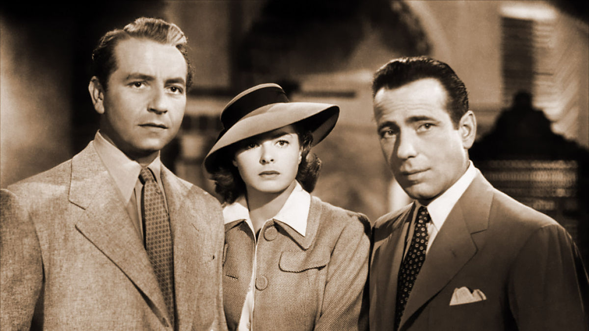 A trio of well-dressed characters stand together in Casablanca