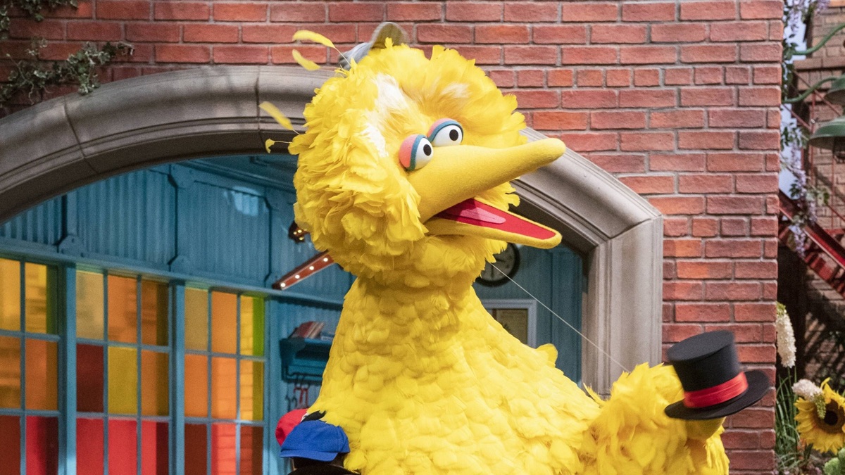 Big Bird holds a top hat in Sesame Street