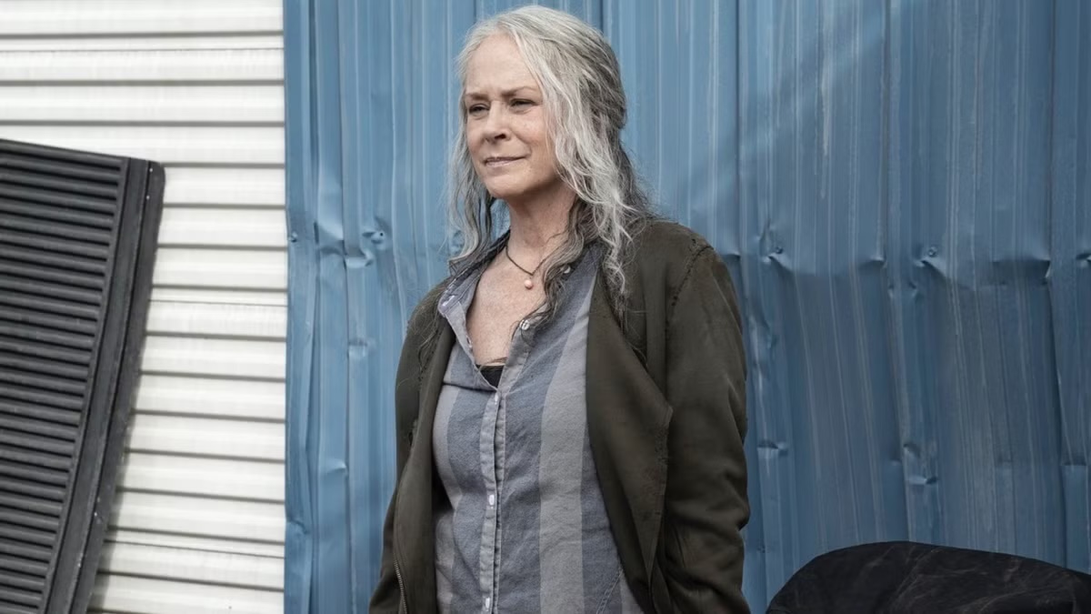Carol Peletier stands outdoors in The Walking Dead