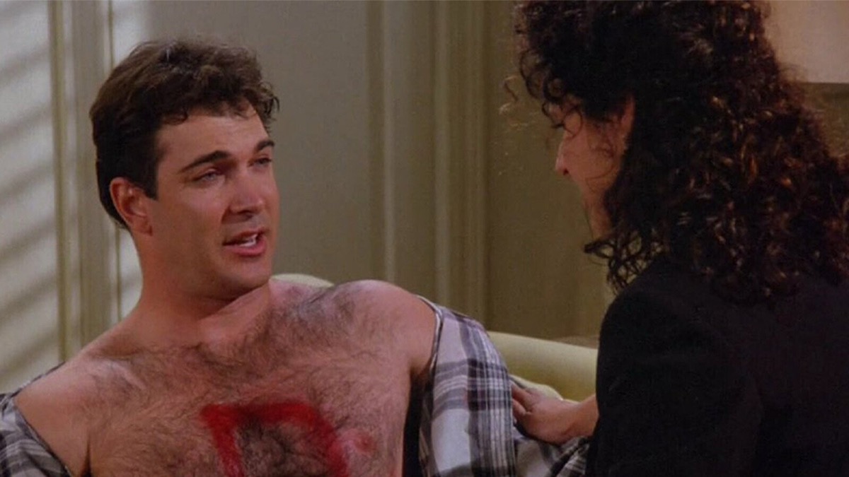 David Puddy sits by Elaine with his shirt unbuttoned in Seinfeld