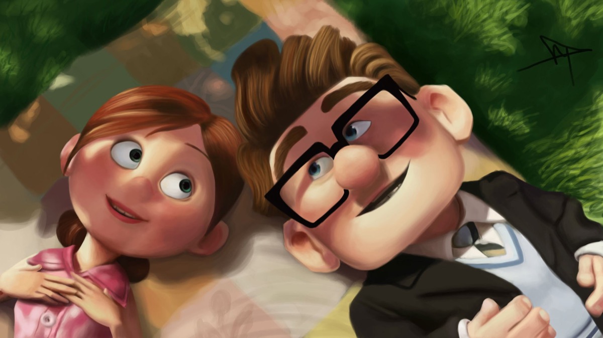 Elle and Carl lay together on a picnic blanket it UP