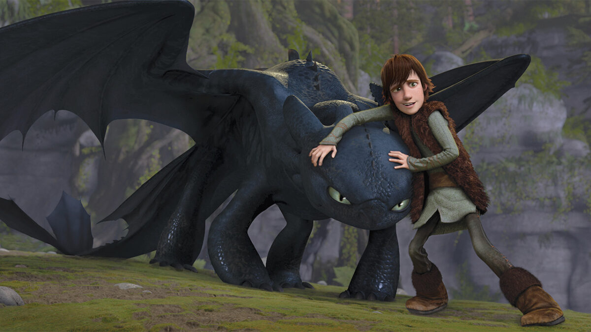 Hiccup the viking tries to hold back the angry dragon Toothless in How to Train Your Dragon