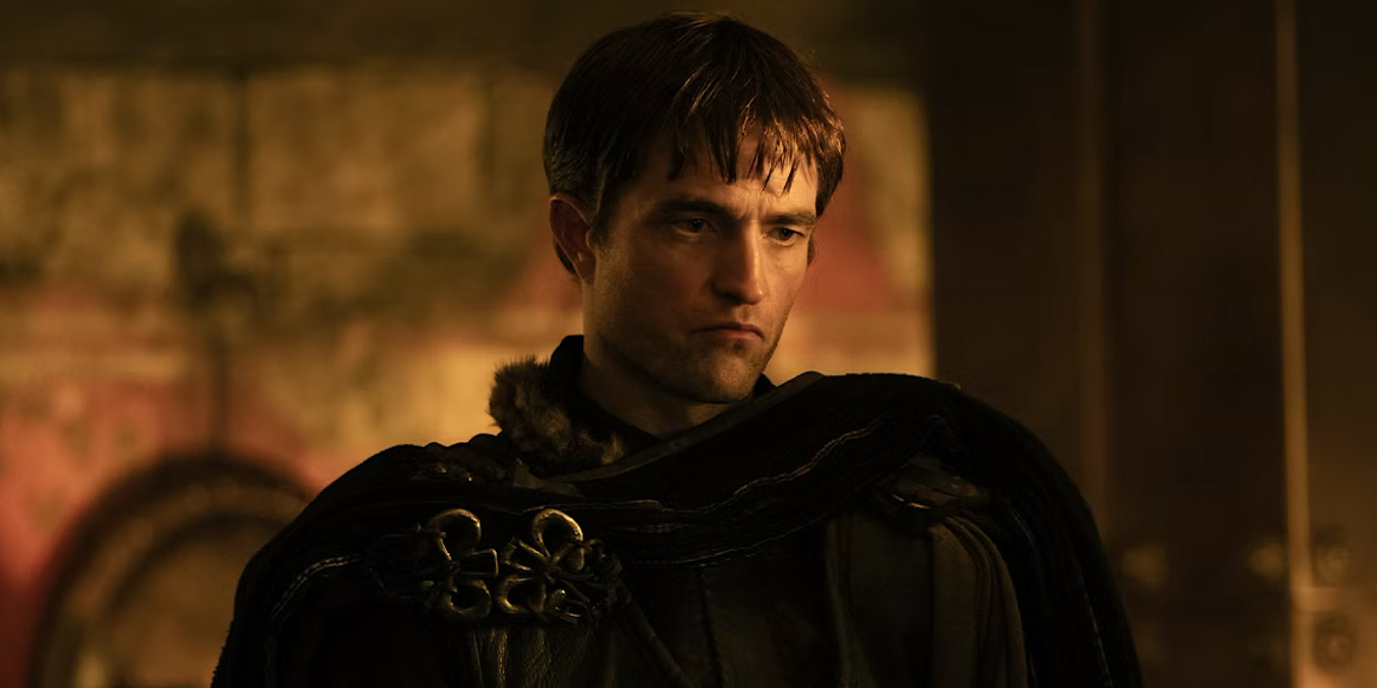 a man looking moody in dim light.