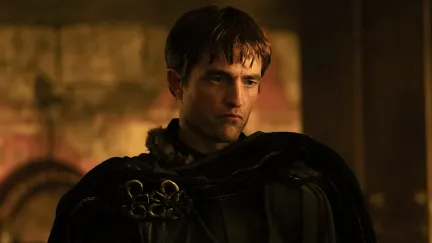 a man looking moody in dim light.