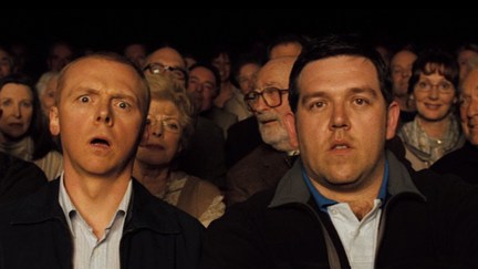two men looking shocked and bemused surrounded by old people