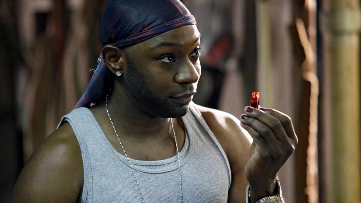 Lafayette holds a vial of blood in True Blood