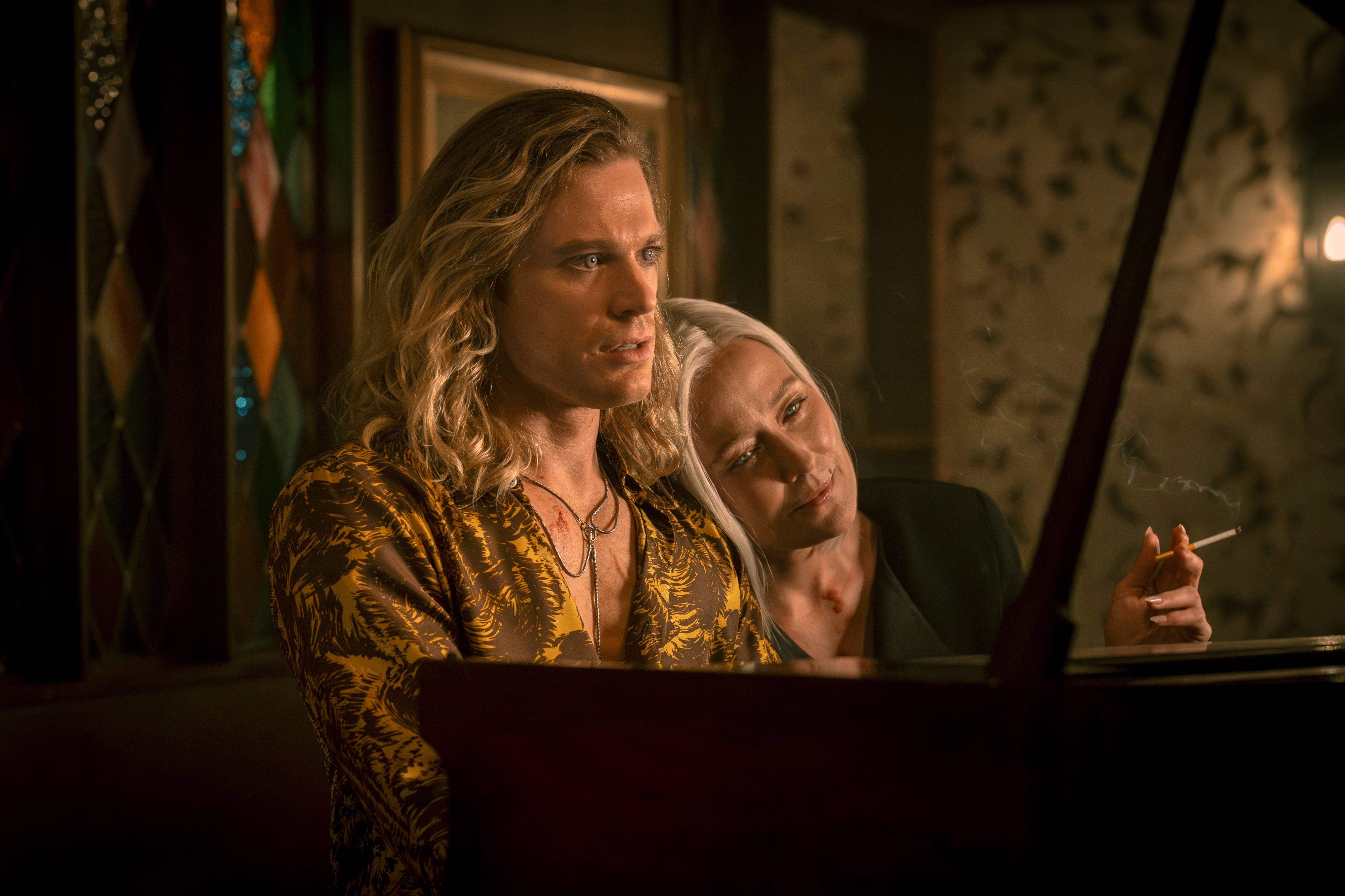 two people sitting at a piano