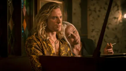 two people sitting at a piano