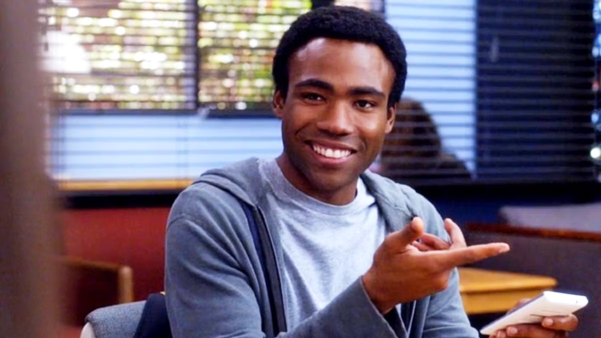 Troy Barnes smiles and gestures in Community