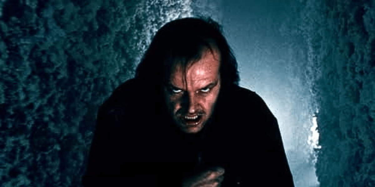 Jack Nicholson stands in a frozen shrub labyrinth; a still from the movie The Shining