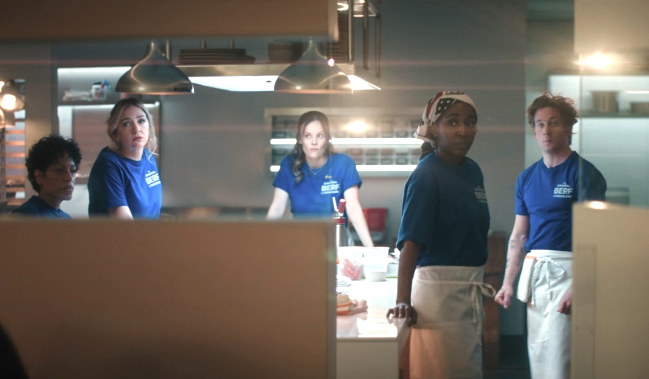 people standing in a kitchen