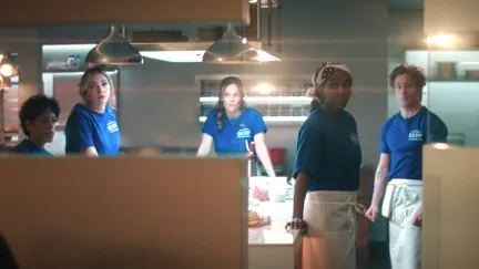 people standing in a kitchen