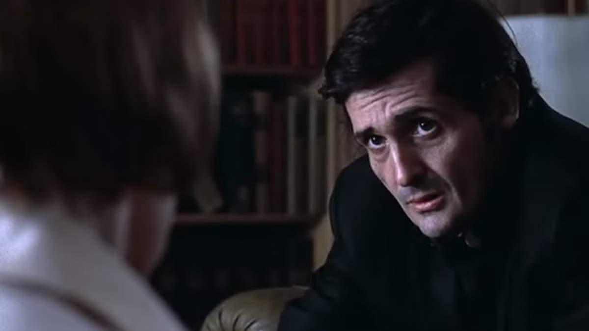 A priest looks concerned at a woman in "The Exorcist"
