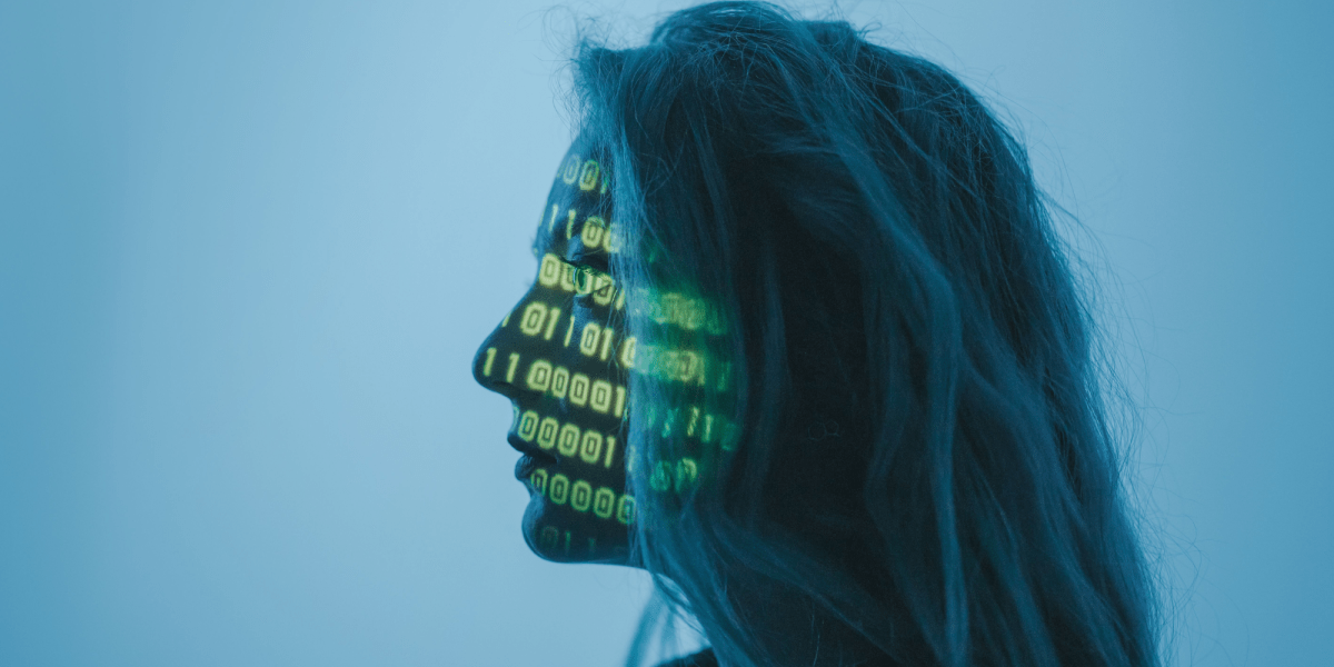a woman with long hair stands in front of a white wall with binary code flashing across her face