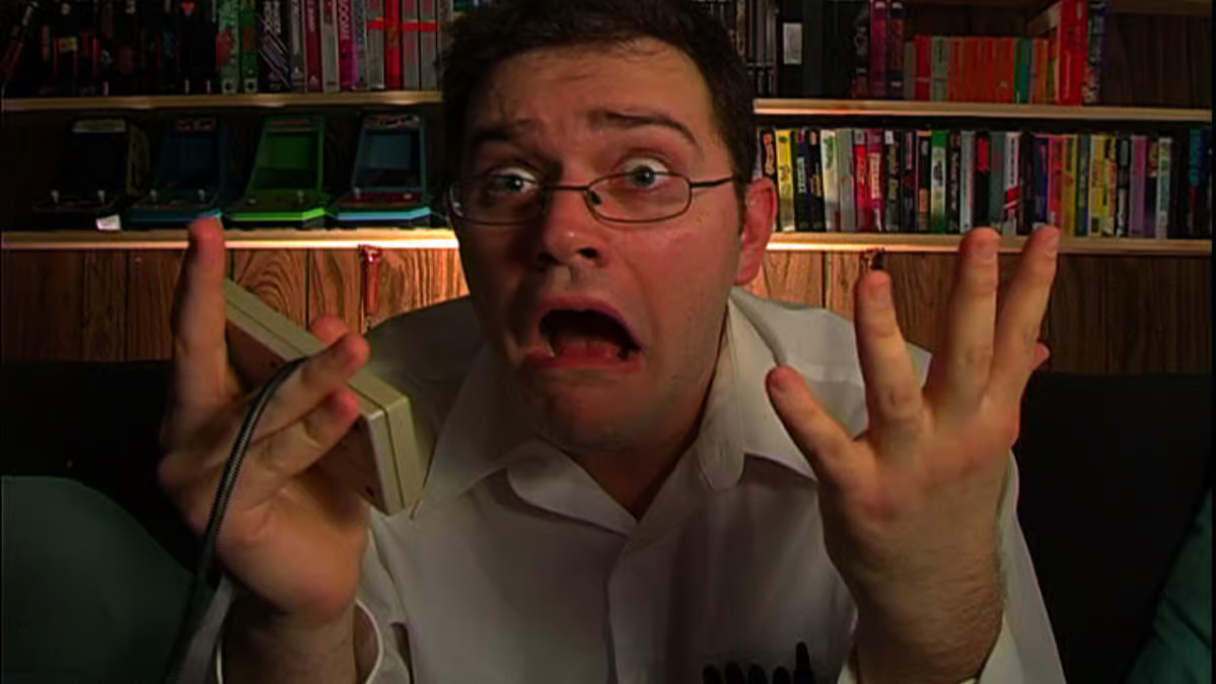 Man looking shocked while holding a game console controller