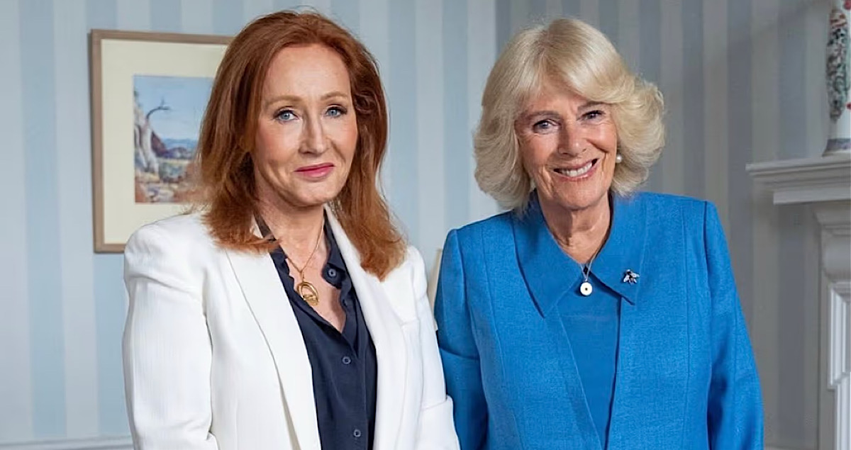 A woman in a white jacket and woman in blue jacket smiling