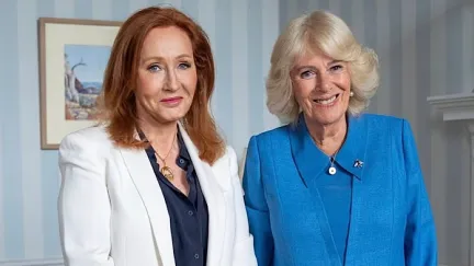 A woman in a white jacket and woman in blue jacket smiling