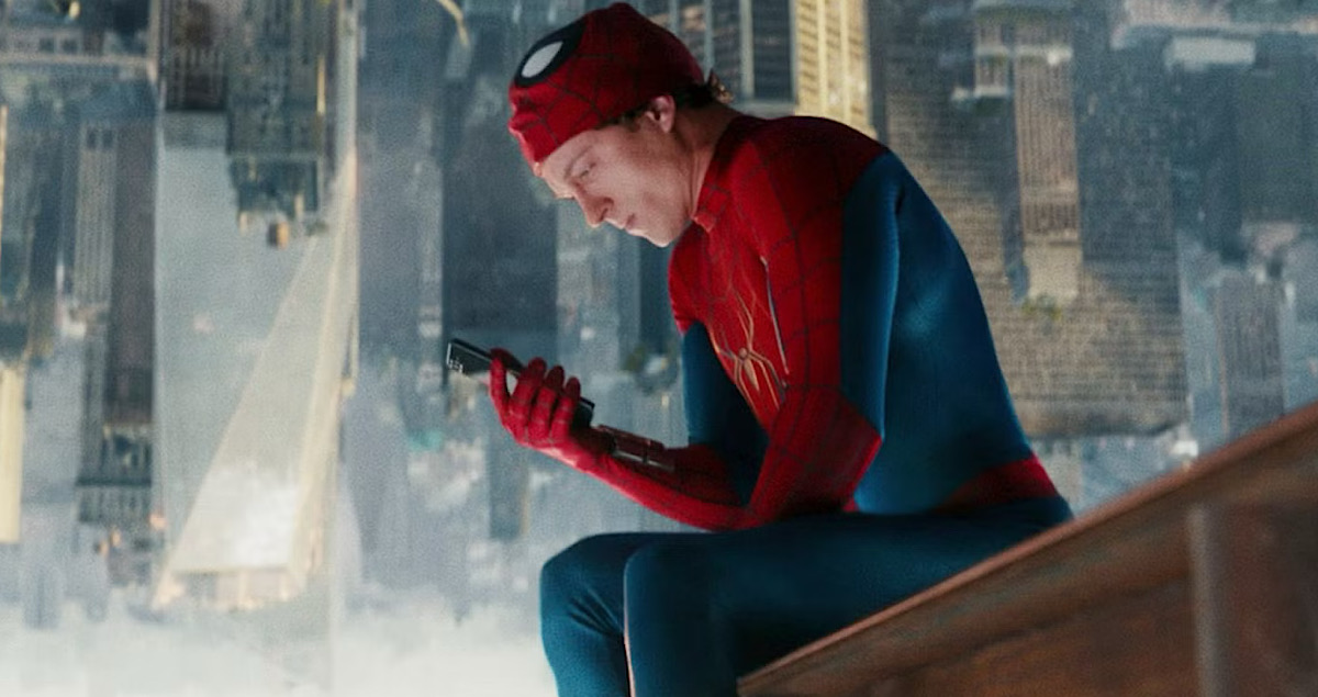 a man in a superhero costume looking at a phone