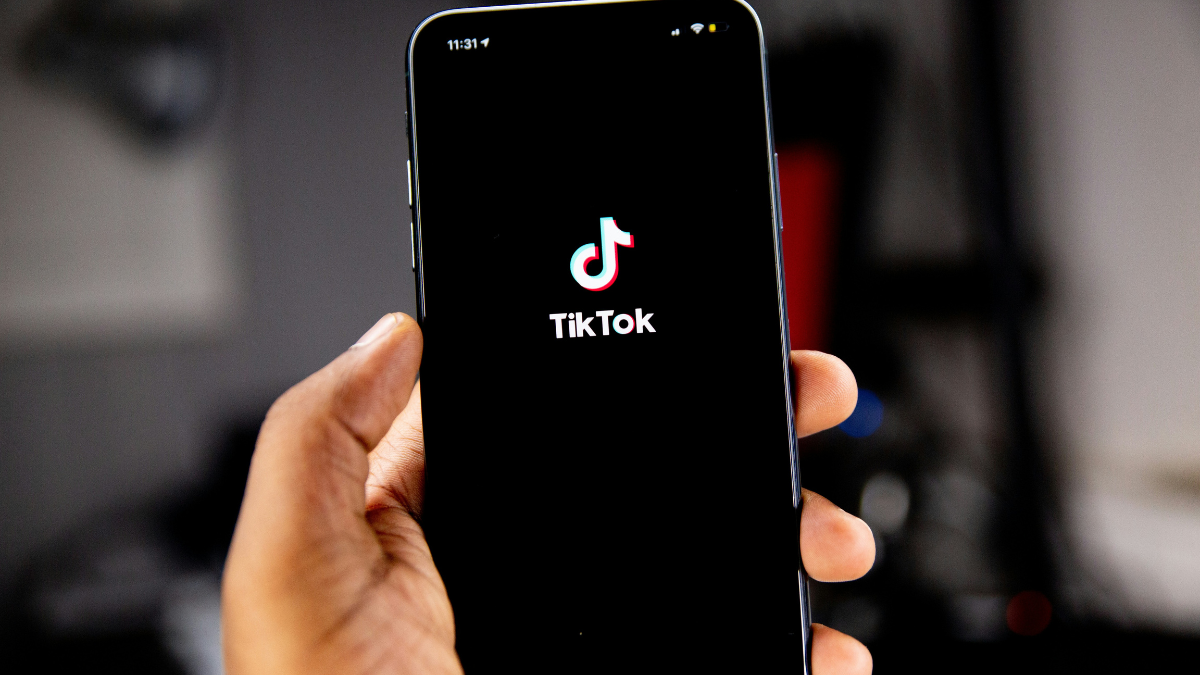 hand holding phone on the TikTok app.