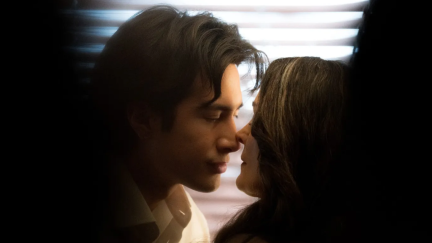 Hudson Williams and Carrie-Anne Moss kissing