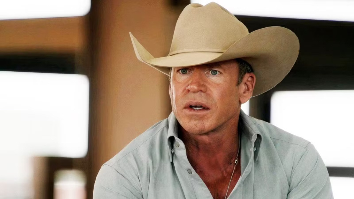 A man in a cowboy hat looks surprised