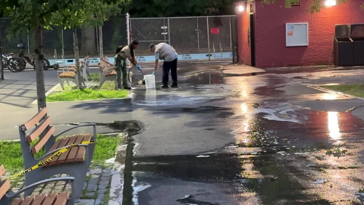 Cleanup crews on the scene after a 10-year-old girl was injured in a fireworks accident in a park.