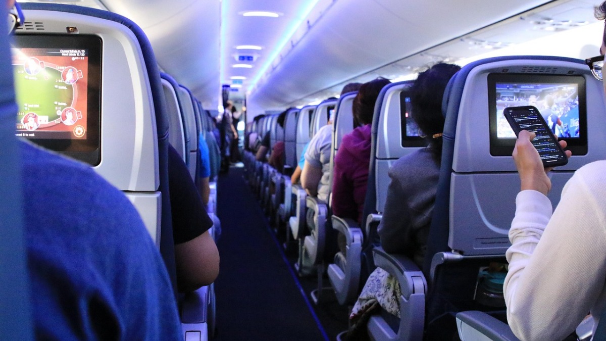 Photo of a plane aisle with people in seats