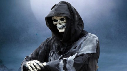 The Grim Reaper resting on a scythe in the moonlight