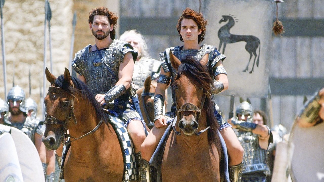 Actors Eric Bana and Orlando Bloom in the movie Troy (2004) horse-riding in warrior costumes.